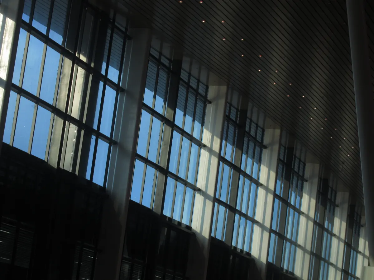 Angled glass building facade with geometric reflections